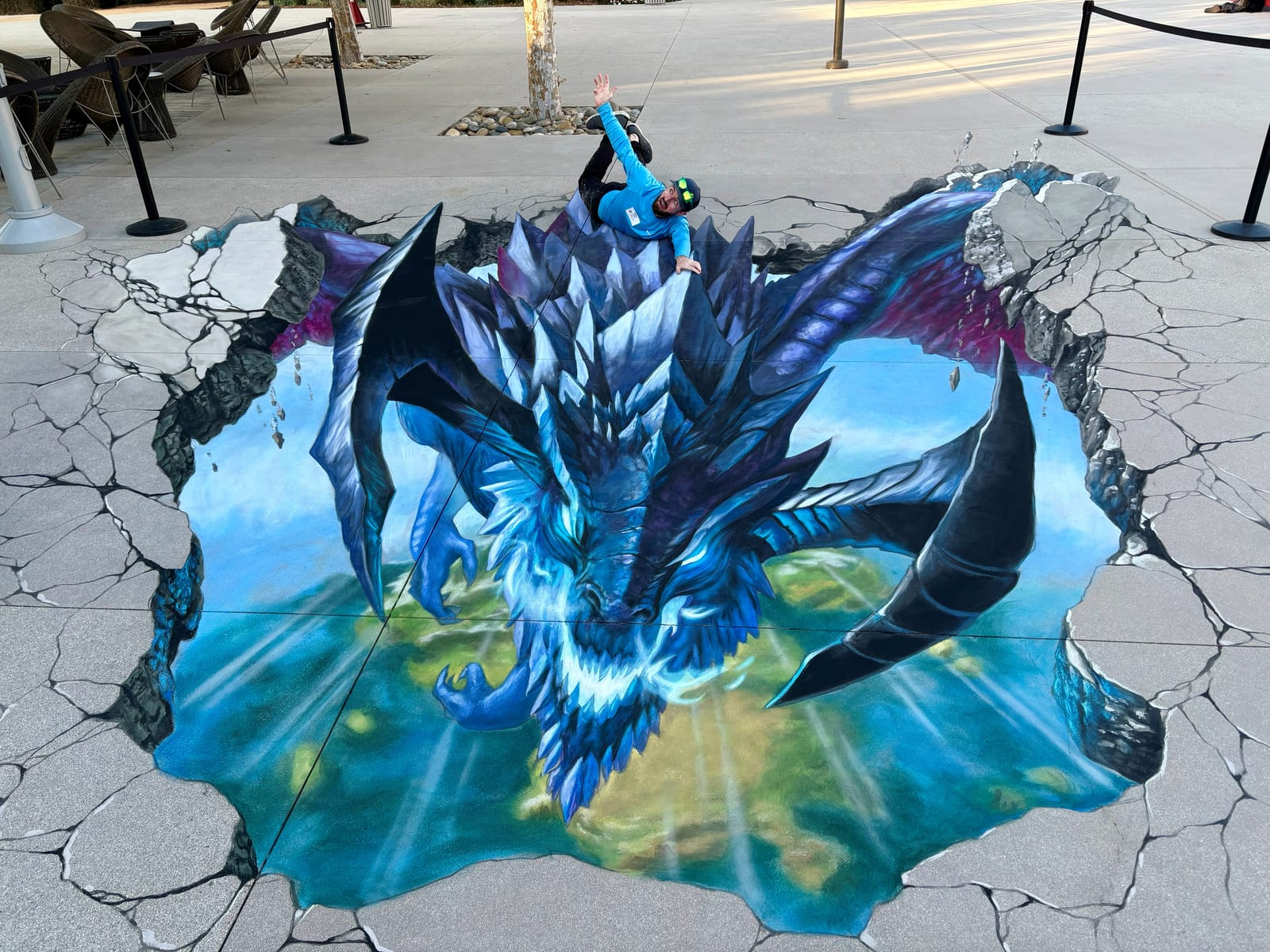 Elder Dragon 3D chalk art illusion bursting through the pavement, a 15ft x 30ft street painting by Chris Carlson commissioned by Riot Games in Santa Monica, California